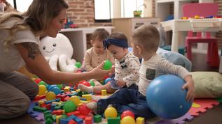 teacher-preschool-students-playing-with-balls-sitt