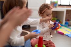 adorable-caucasian-girl-playing-with-hoops-sitting